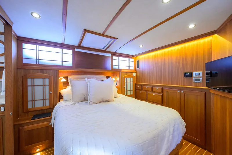 Vienna Yacht Photos Pics Luxurious 2018 Sabre 48 Salon Express bedroom with elegant wood paneling and ambient lighting.