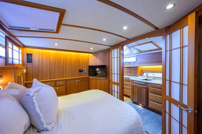 Vienna Yacht Photos Pics Luxurious 2018 Sabre 48 Salon Express bedroom with wood paneling and ensuite bathroom.