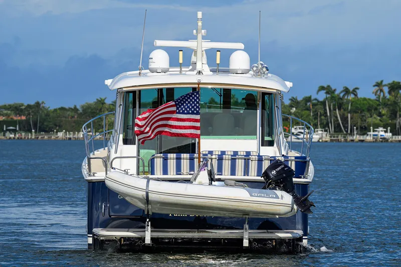 Vienna Yacht Photos Pics 2018 Sabre 48 Salon Express yacht with American flag and dinghy on water.