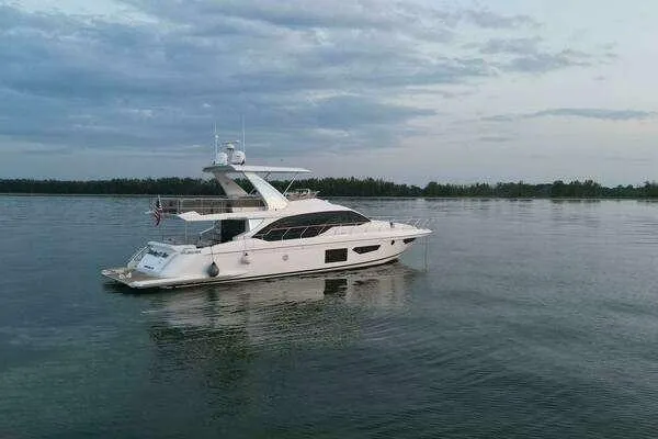  Yacht Photos Pics 2020 Azimut 66 yacht on calm water under a cloudy sky.