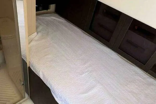  Yacht Photos Pics 2020 Azimut 66 yacht interior with a neatly made bed and modern design.