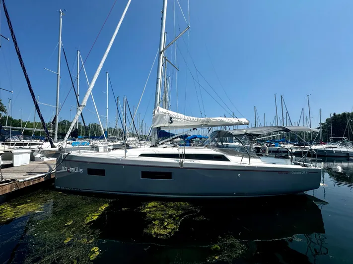  Yacht Photos Pics 2023 Beneteau Oceanis 34.1 sailboat docked in a marina under clear blue skies.