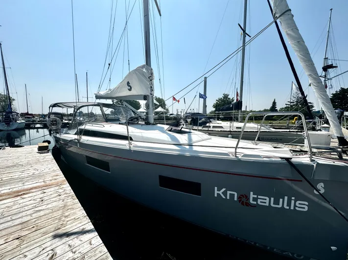  Yacht Photos Pics 2023 Beneteau Oceanis 34.1 sailboat docked at marina under clear sky.