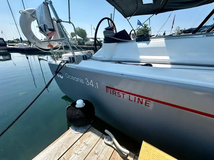  Yacht Photos Pics 2023 Beneteau Oceanis 34.1 sailboat docked at marina, side view.
