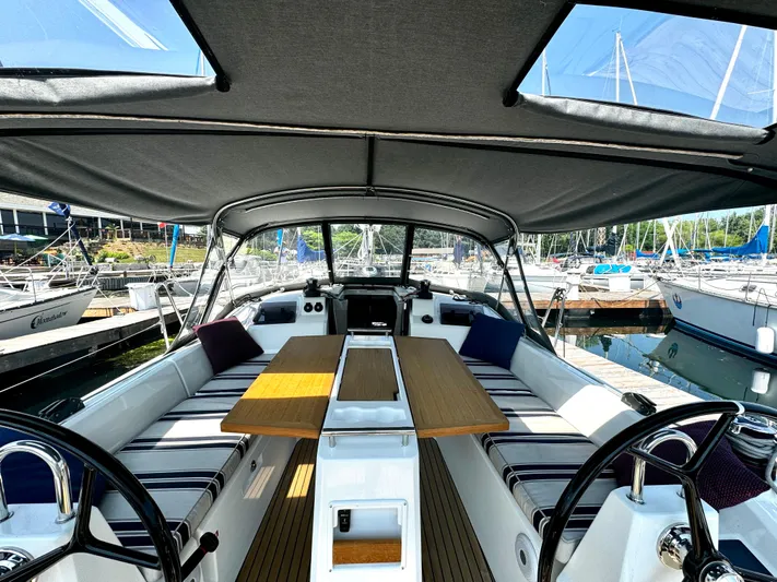  Yacht Photos Pics 2023 Beneteau Oceanis 34.1 yacht cockpit with seating and table, docked at marina.