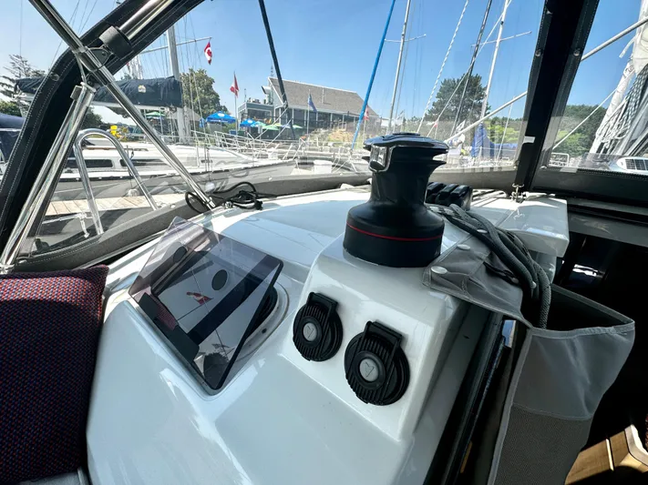  Yacht Photos Pics Cockpit view of 2023 Beneteau Oceanis 34.1 sailboat with winch and control panel.