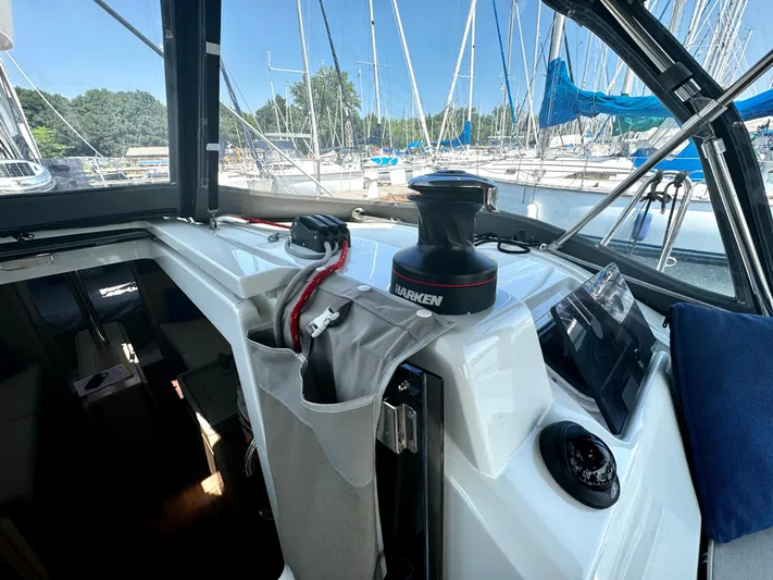  Yacht Photos Pics 2023 Beneteau Oceanis 34.1 cockpit with winch, ropes, and navigation equipment.