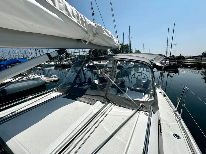  Yacht Photos Pics 2023 Beneteau Oceanis 34.1 sailboat docked at marina, clear sky background.