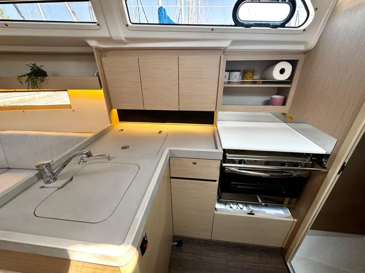  Yacht Photos Pics Modern kitchen interior of 2023 Beneteau Oceanis 34.1 yacht with sleek cabinetry and appliances.