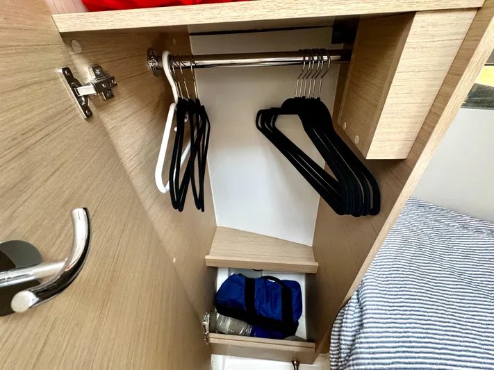  Yacht Photos Pics Closet interior of 2023 Beneteau Oceanis 34.1 yacht with hangers and storage.