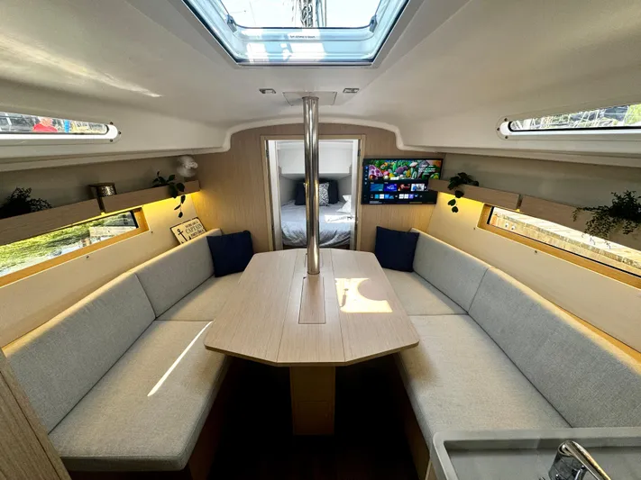  Yacht Photos Pics 2023 Beneteau Oceanis 34.1 interior with modern seating, skylight, and TV.