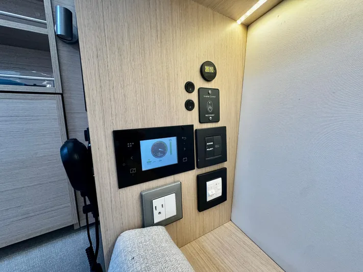 Yacht Photos Pics Control panel in 2023 Beneteau Oceanis 34.1 yacht interior, featuring modern switches and outlets.