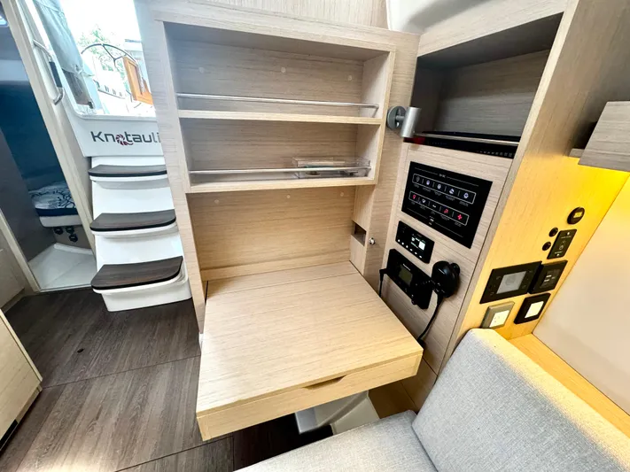  Yacht Photos Pics 2023 Beneteau Oceanis 34.1 interior with control panel and wooden cabinetry.