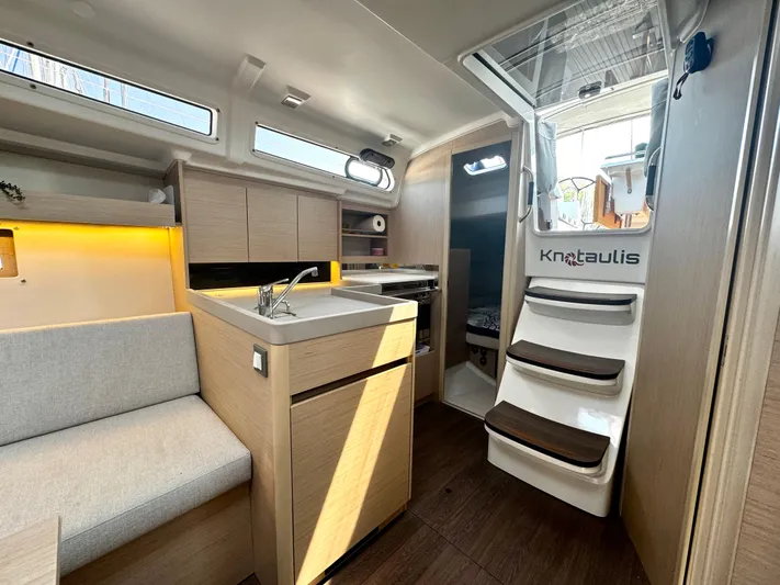  Yacht Photos Pics Interior of 2023 Beneteau Oceanis 34.1 yacht, featuring modern kitchen and seating area.