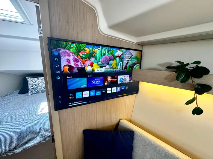  Yacht Photos Pics Interior of 2023 Beneteau Oceanis 34.1 yacht with TV and cozy seating area.