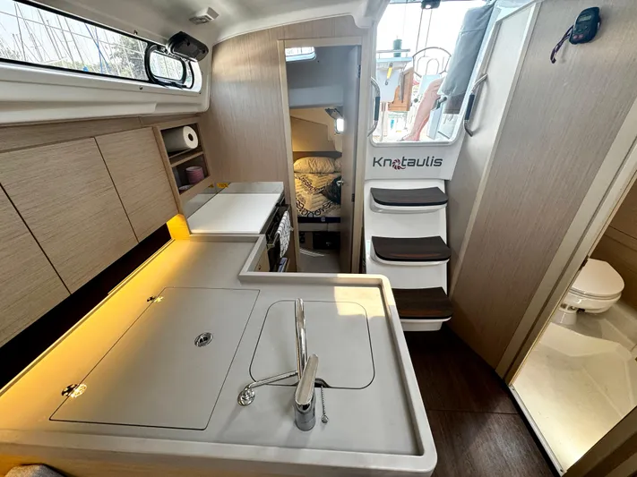  Yacht Photos Pics 2023 Beneteau Oceanis 34.1 yacht interior with modern kitchen and cozy cabin.