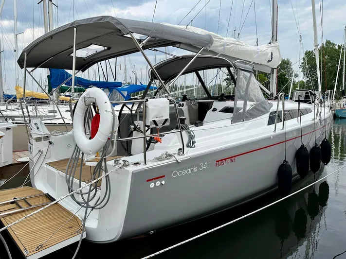  Yacht Photos Pics 2023 Beneteau Oceanis 34.1 sailboat docked at marina, featuring sleek design and modern amenities.