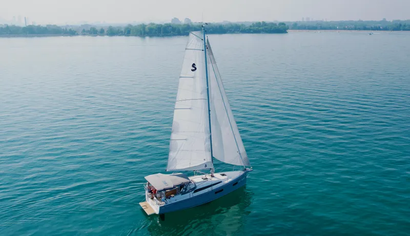  Yacht Photos Pics 2023 Beneteau Oceanis 34.1 sailing on calm waters under clear skies.