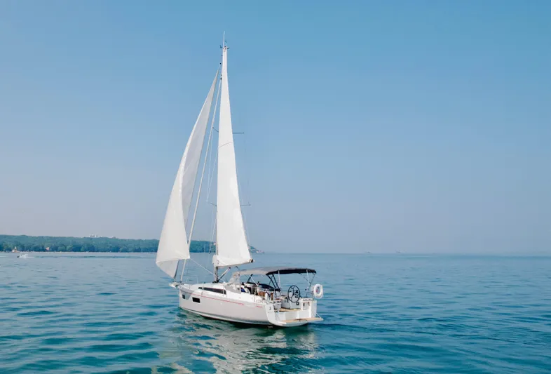  Yacht Photos Pics 2023 Beneteau Oceanis 34.1 sailing on calm blue waters under clear skies.