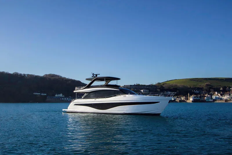  Yacht Photos Pics 2025 Princess Y72 Motor Yacht on serene water with scenic background.