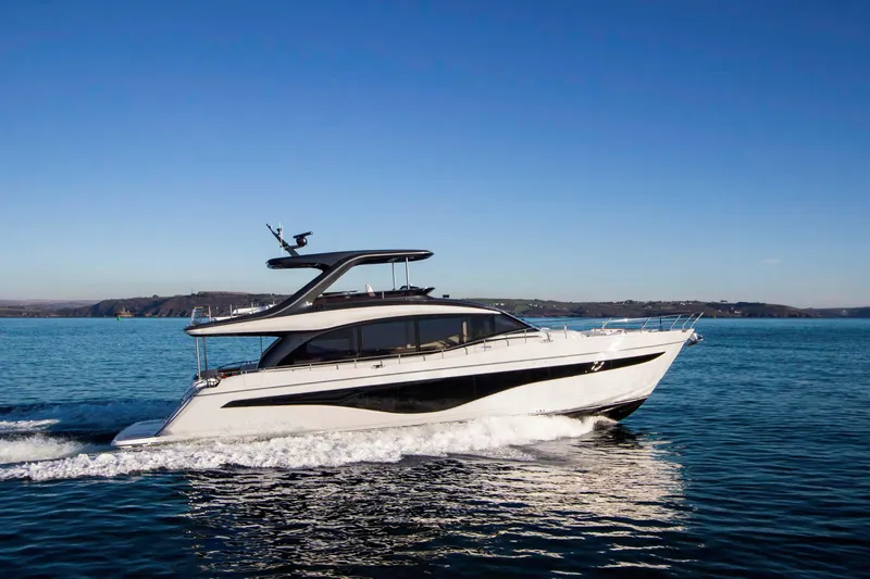  Yacht Photos Pics 2025 Princess Y72 Motor Yacht cruising on open water under clear blue skies.