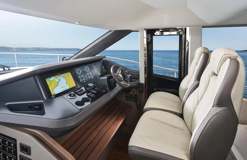  Yacht Photos Pics 2025 Princess Y72 Motor Yacht helm with modern navigation displays and luxurious seating.
