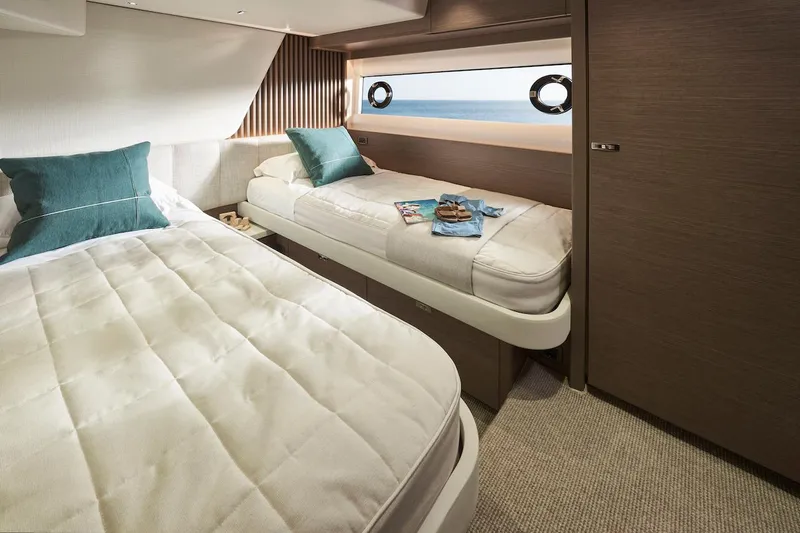  Yacht Photos Pics Luxurious cabin interior of 2025 Princess Y72 Motor Yacht with twin beds and ocean view.