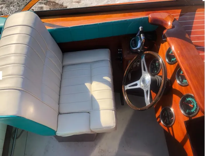 Arrivederci Yacht Photos Pics 2018 Riva Reets Replica Super Aquarama boat interior with white leather seat and wooden dashboard.