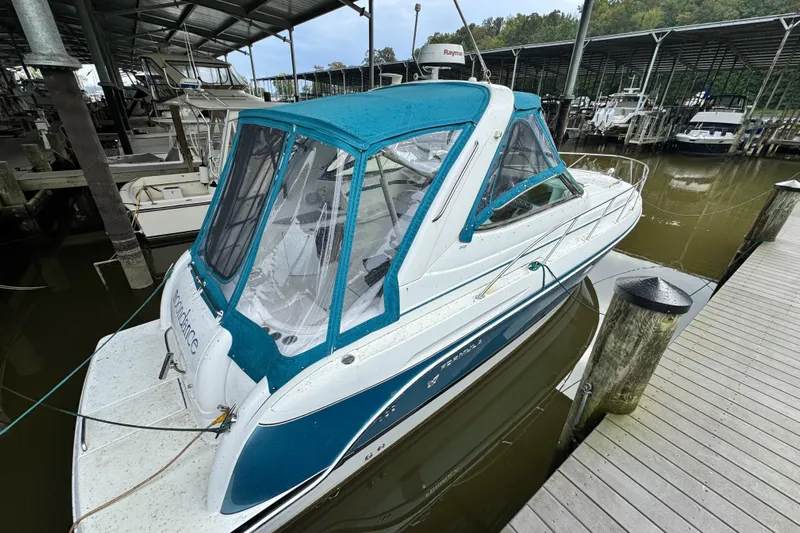  Yacht Photos Pics 2005 Formula 34 Performance Cruiser docked with blue canopy in marina.