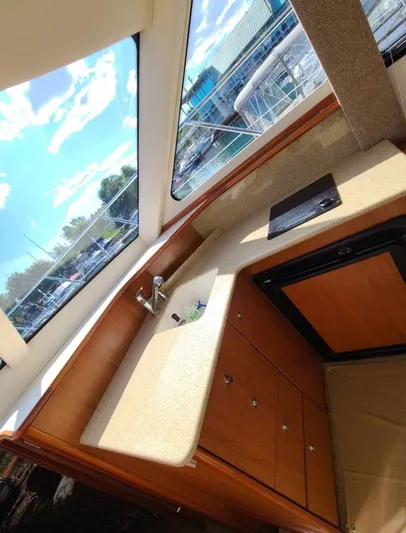  Yacht Photos Pics Interior view of 2008 Silverton 33 Convertible yacht kitchen with sink and cabinets.