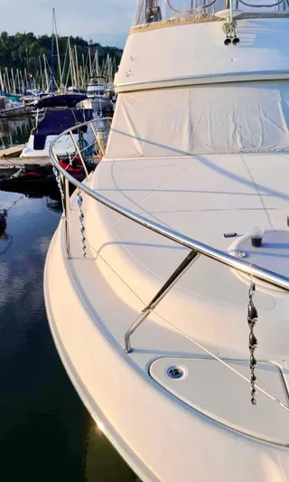  Yacht Photos Pics 2008 Silverton 33 Convertible yacht docked at marina with sailboats in background.