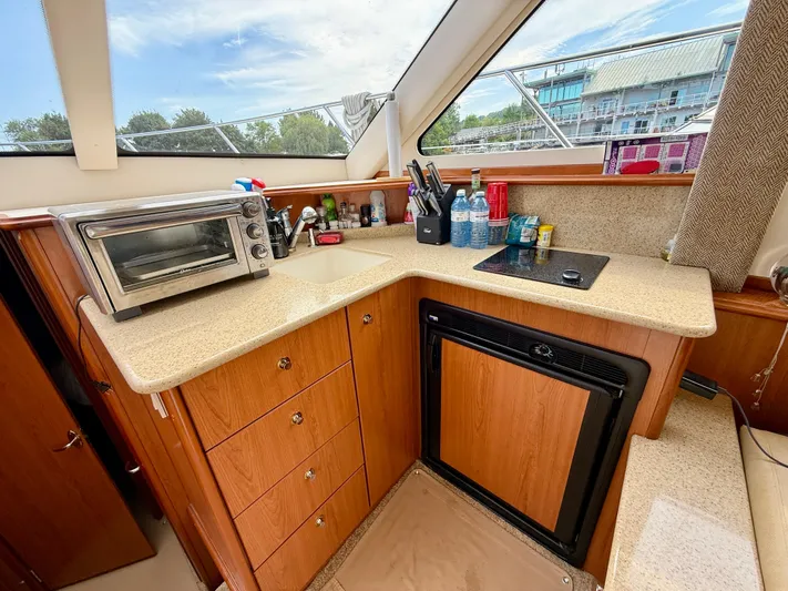  Yacht Photos Pics 2008 Silverton 33 Convertible yacht kitchen with countertop, toaster oven, and mini fridge.