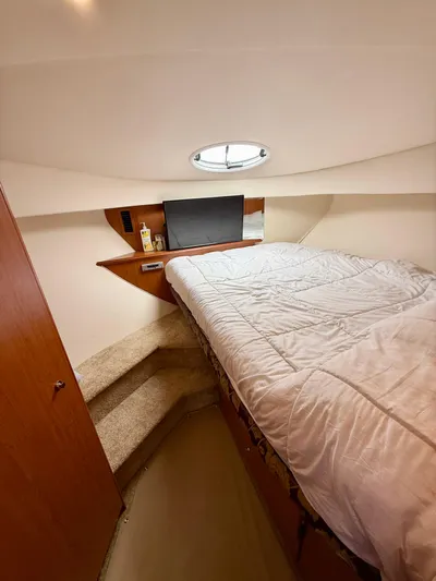  Yacht Photos Pics 2008 Silverton 33 Convertible cabin with bed, porthole, and wooden interior.