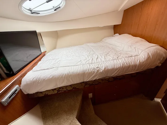  Yacht Photos Pics 2008 Silverton 33 Convertible cabin with bed, TV, and porthole window.