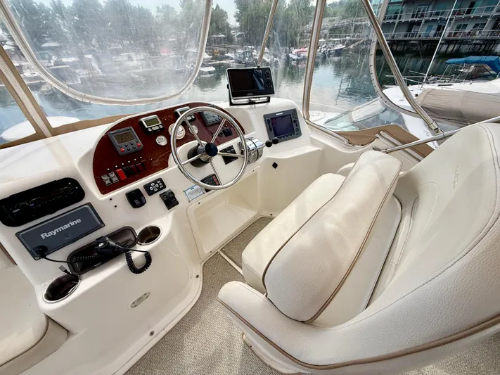  Yacht Photos Pics 2008 Silverton 33 Convertible helm with modern navigation equipment and comfortable seating.