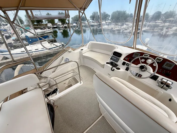  Yacht Photos Pics 2008 Silverton 33 Convertible yacht cockpit with steering wheel, controls, and marina view.