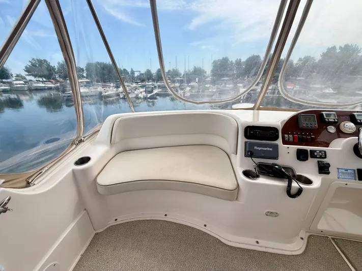  Yacht Photos Pics 2008 Silverton 33 Convertible boat interior with helm, seating, and marina view.