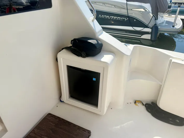  Yacht Photos Pics 2008 Silverton 33 Convertible boat interior with mini fridge and docked Monterey boat.