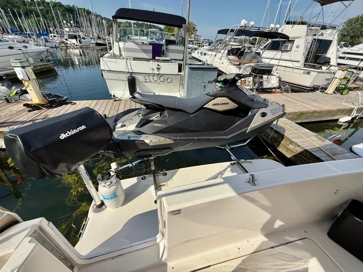  Yacht Photos Pics 2008 Silverton 33 Convertible docked with Sea-Doo jet ski, marina background.