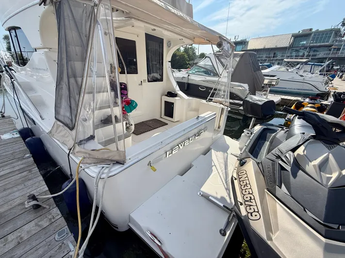  Yacht Photos Pics 2008 Silverton 33 Convertible yacht docked with jet ski nearby.