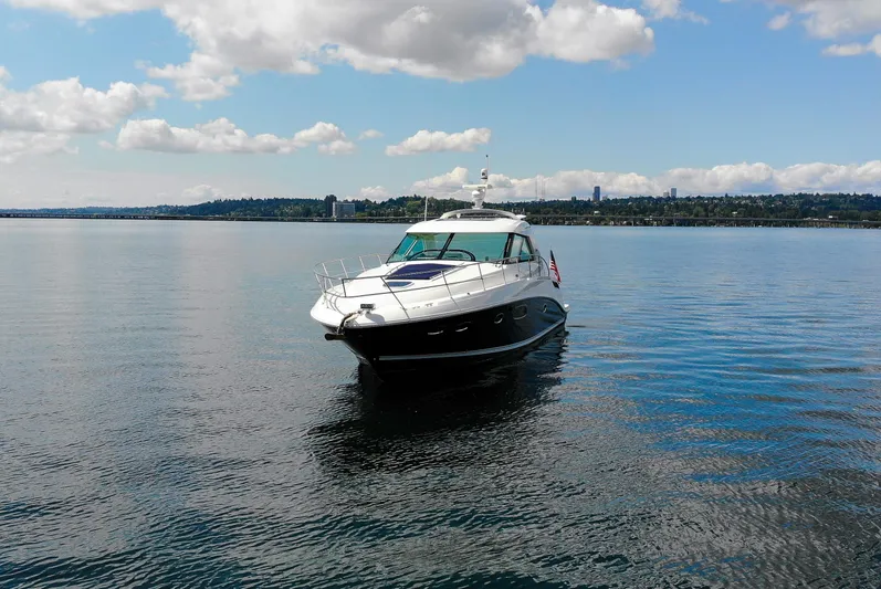  Yacht Photos Pics 2011 Sea Ray 450 Sundancer yacht on calm water under a partly cloudy sky.