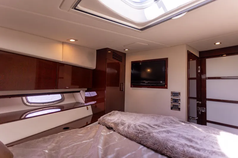  Yacht Photos Pics Luxurious cabin interior of 2011 Sea Ray 450 Sundancer yacht with TV and skylight.
