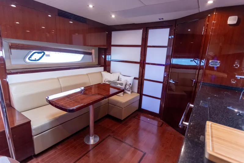  Yacht Photos Pics Luxurious interior of 2011 Sea Ray 450 Sundancer yacht with elegant seating and wooden finishes.