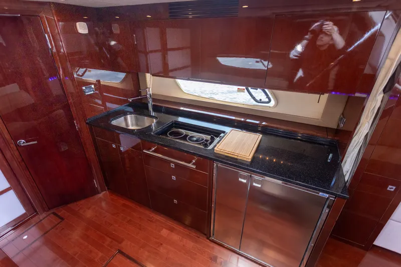  Yacht Photos Pics Luxurious 2011 Sea Ray 450 Sundancer yacht kitchen with sleek wood cabinetry and modern appliances.