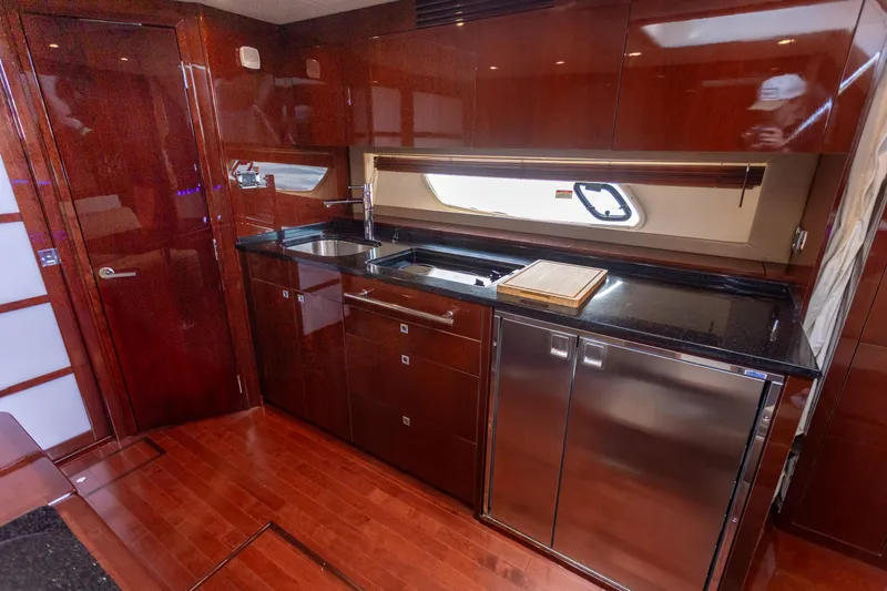  Yacht Photos Pics Luxurious kitchen interior of 2011 Sea Ray 450 Sundancer yacht with sleek cabinetry.