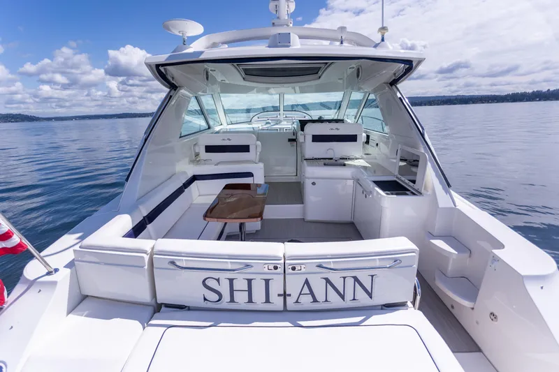  Yacht Photos Pics 2011 Sea Ray 450 Sundancer yacht on calm water, featuring spacious deck and seating area.