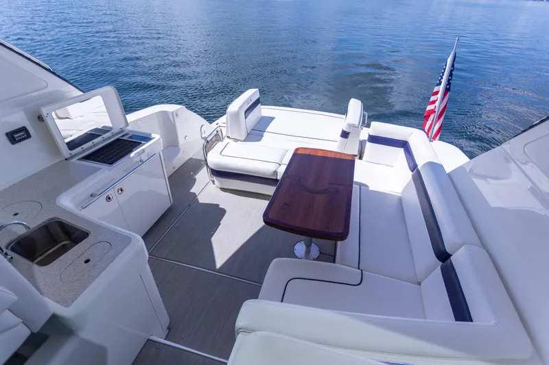  Yacht Photos Pics Luxurious 2011 Sea Ray 450 Sundancer yacht deck with seating and American flag.