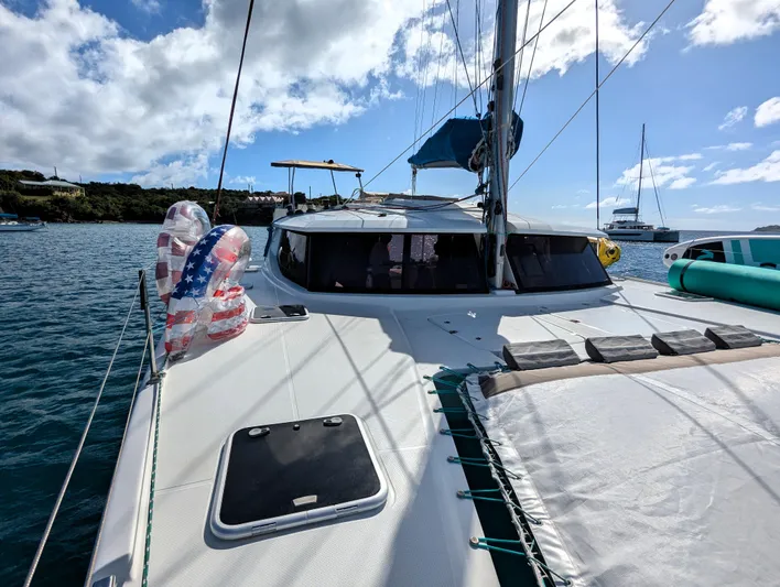 Seatitudes Yacht Photos Pics 2017 Fountaine Pajot Helia 44 Evolution catamaran on water, sunny day, American flag float.