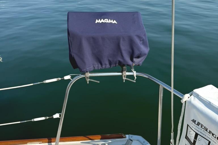 Sailboat grill with cover on Pearson 33-2, 1986 model, over calm water.