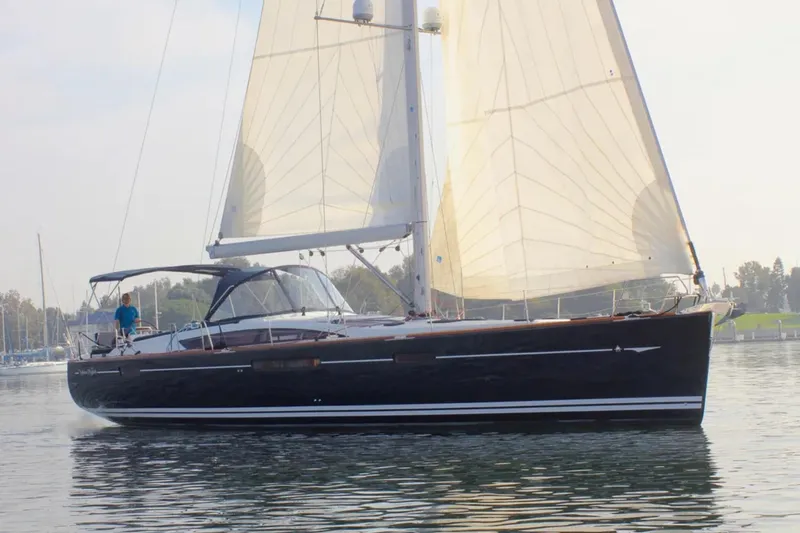 Tenacity Yacht Photos Pics 2011 Jeanneau 57 sailboat cruising on calm waters with sails fully raised.